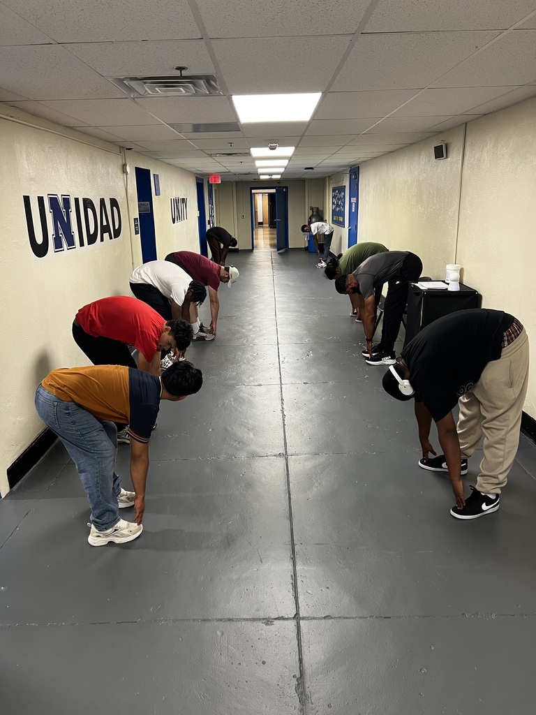 Students are lined up along the walls cooling down