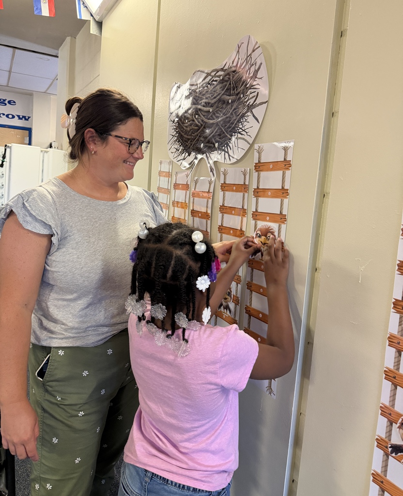 The guidance counselor and a student moving an eagle up a ladder