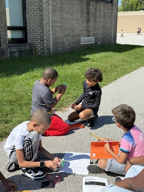 Fourth graders work to create a simple electrical system in science class.