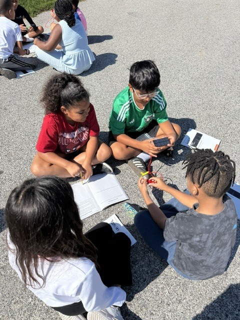 Fourth graders work to create a simple electrical system in science class.