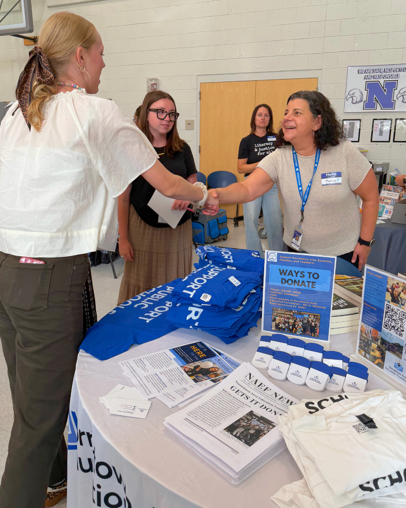 New teacher shaking hands with a community partner.