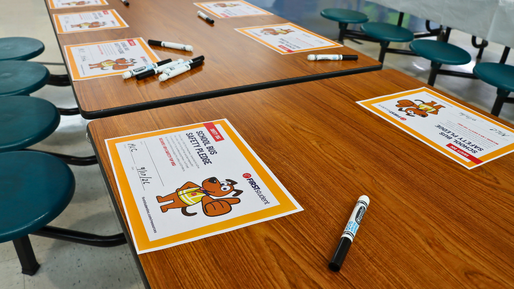 School Bus Safety Pledge papers on table ready for students to sign.