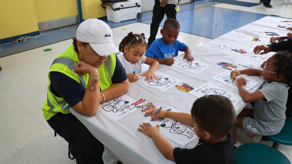 Students coloring a page of Safety Dog.