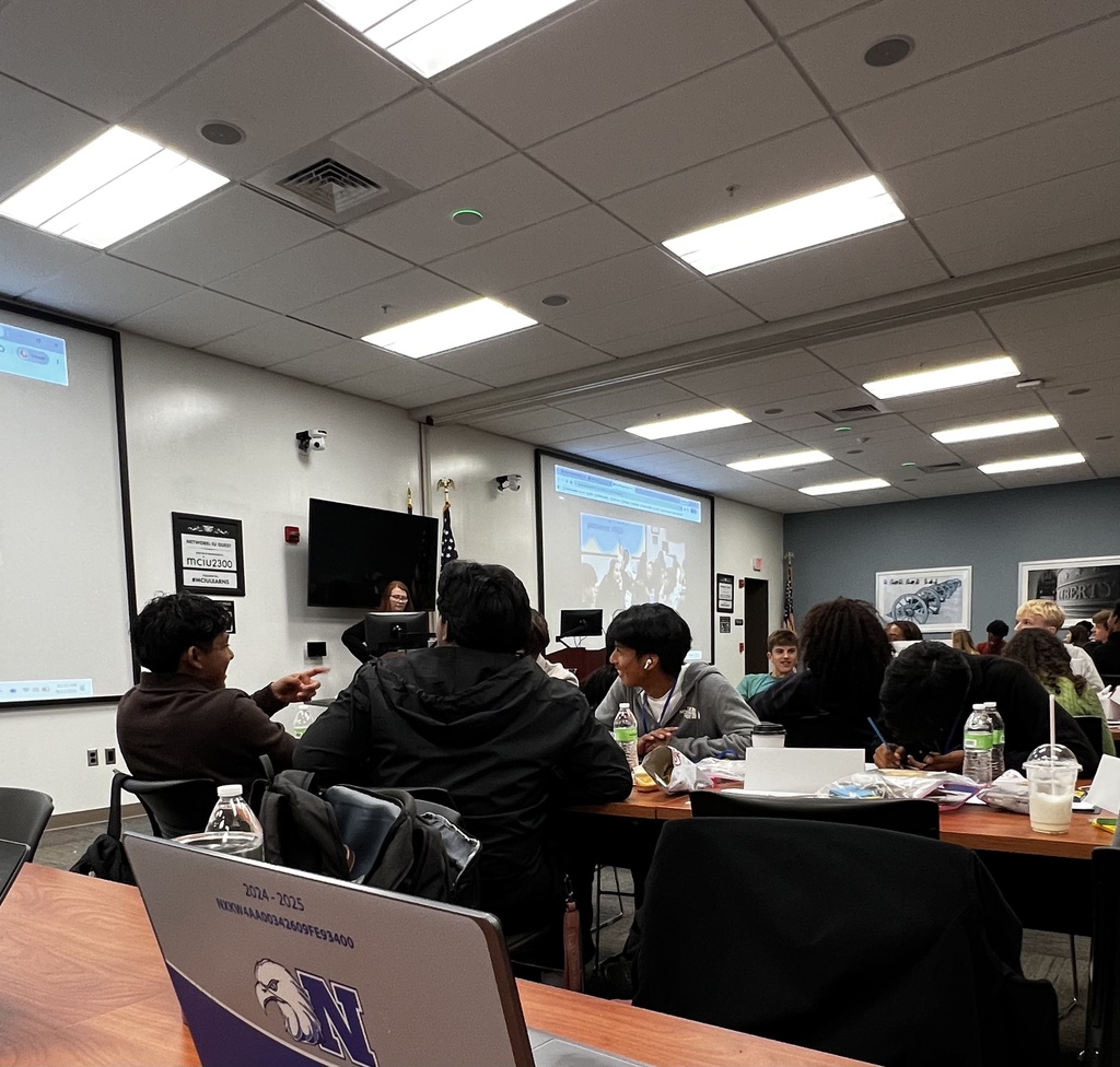 Students are watching a video on the screen