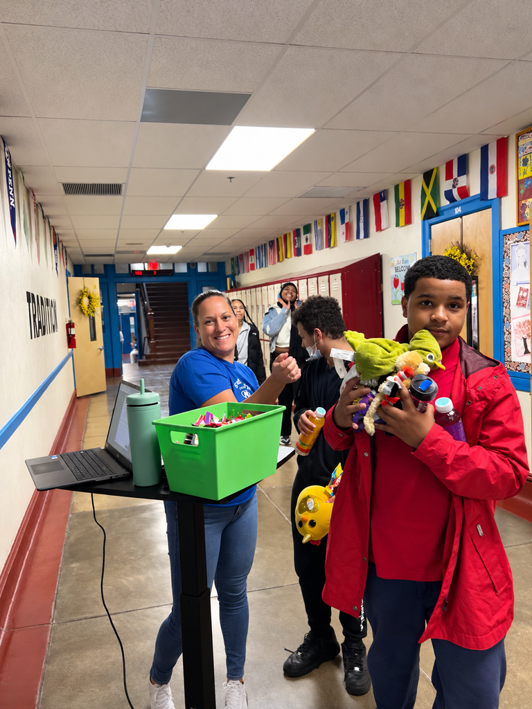 Students are walking away with their purchased items from the PBIS stand.