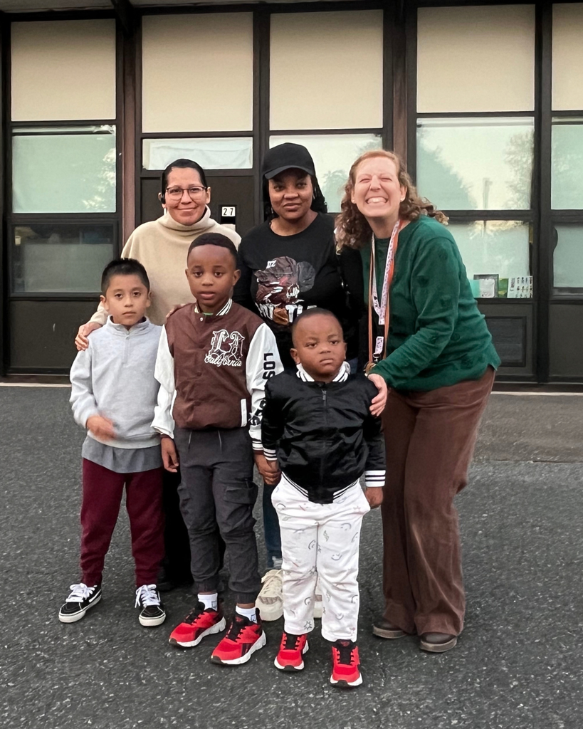Parents, students, and a teacher pose for group photo.