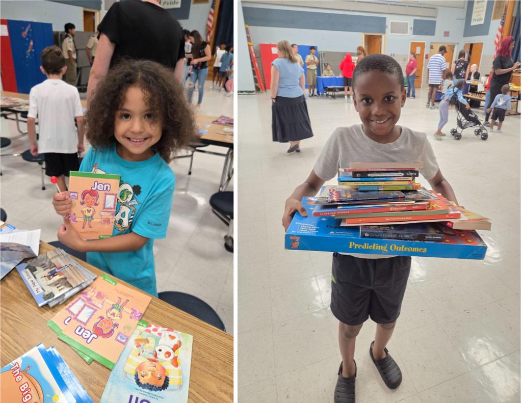 Elementary school students smile as they select books during a Back-to-School Night event.