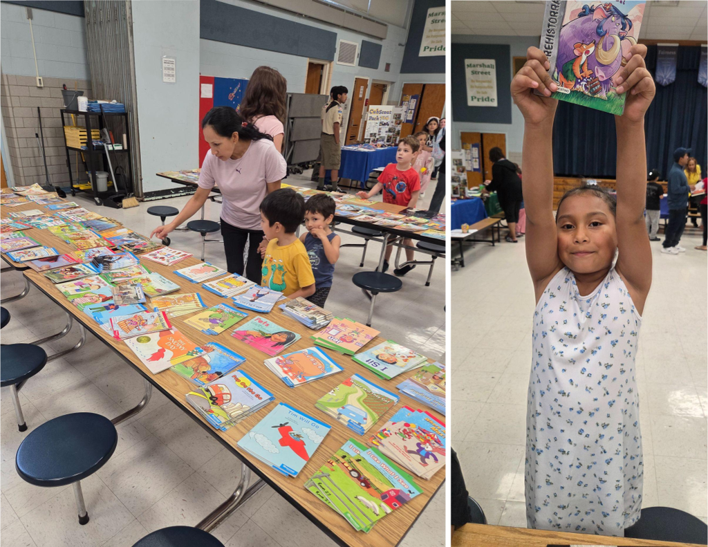Elementary school students smile as they select books during a Back-to-School Night event.