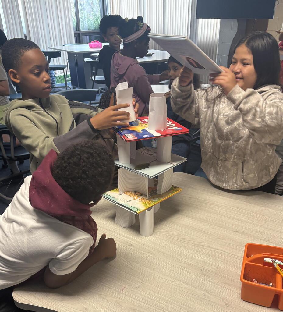 students work together to build a tower during library