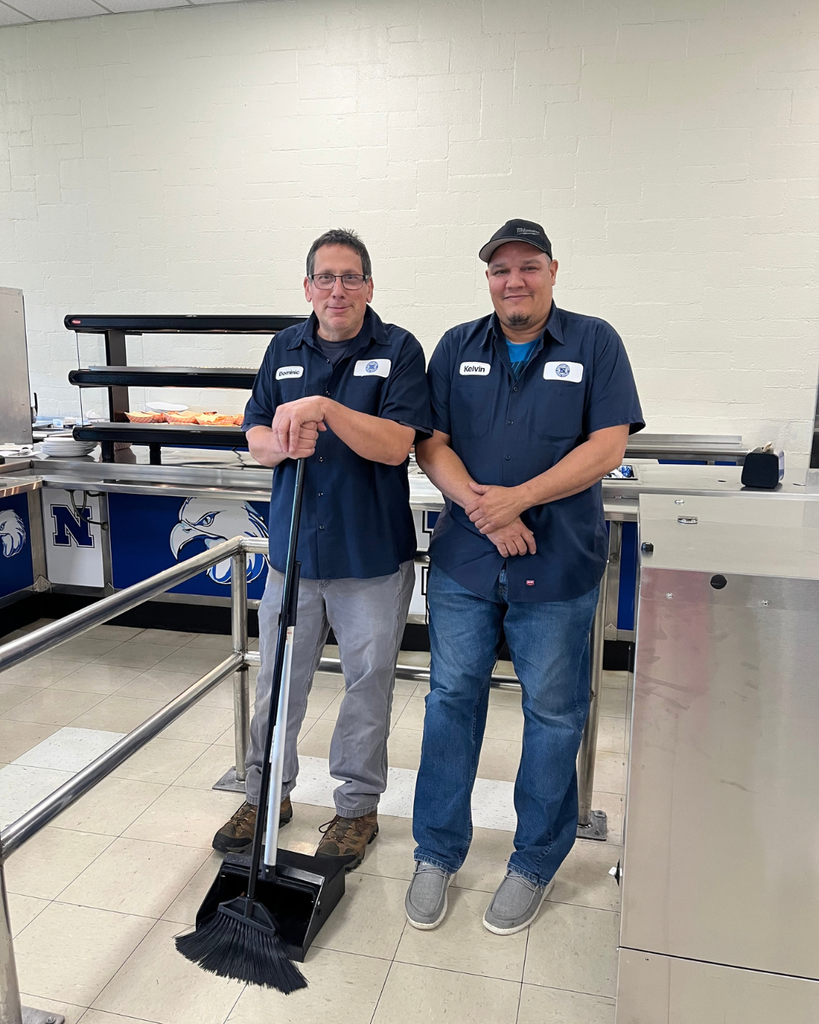 Two custodial team members pose for photo.