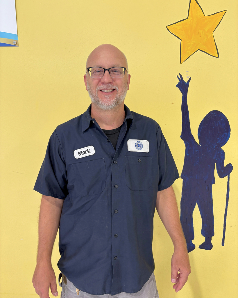 Custodian smiles for photo.