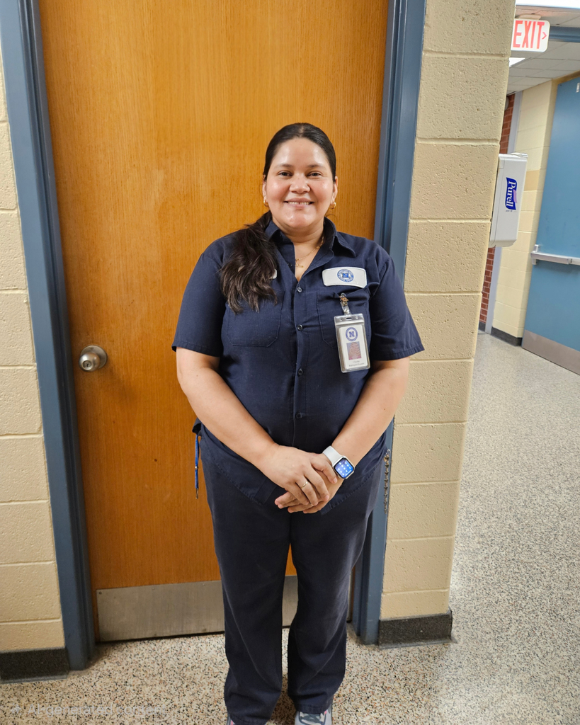 Custodian smiles for photo.