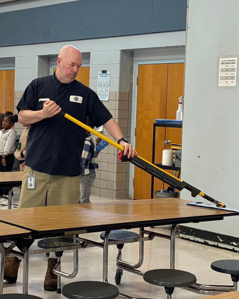 Custodian cleaning off lunch table.
