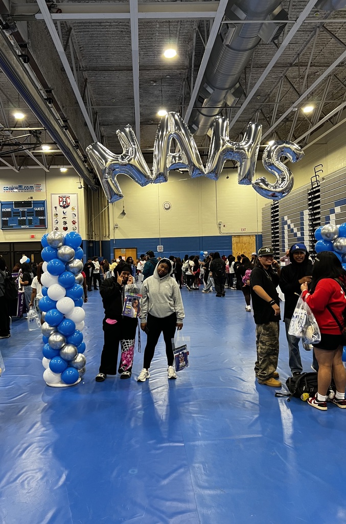 Students are standing under the NAHS balloon arch