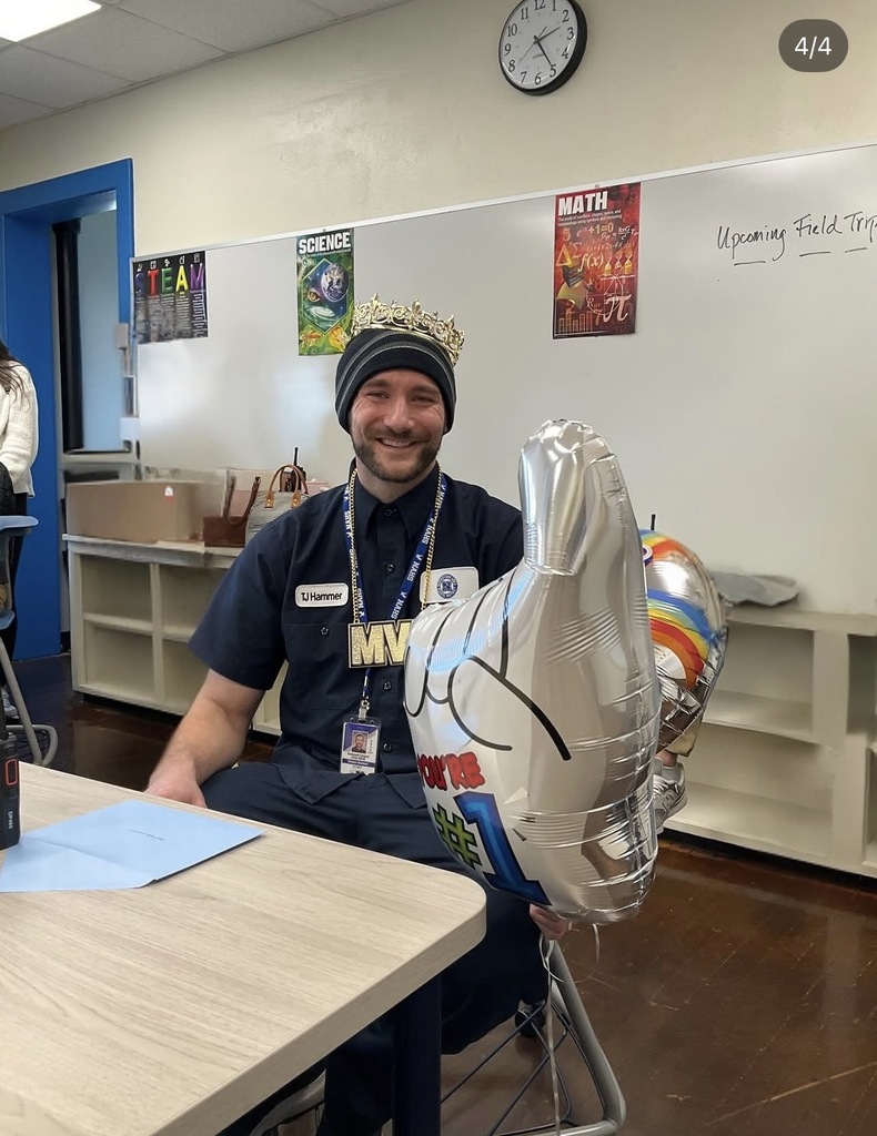 Our head custodian is wearing a crown and holding a "number 1" balloon