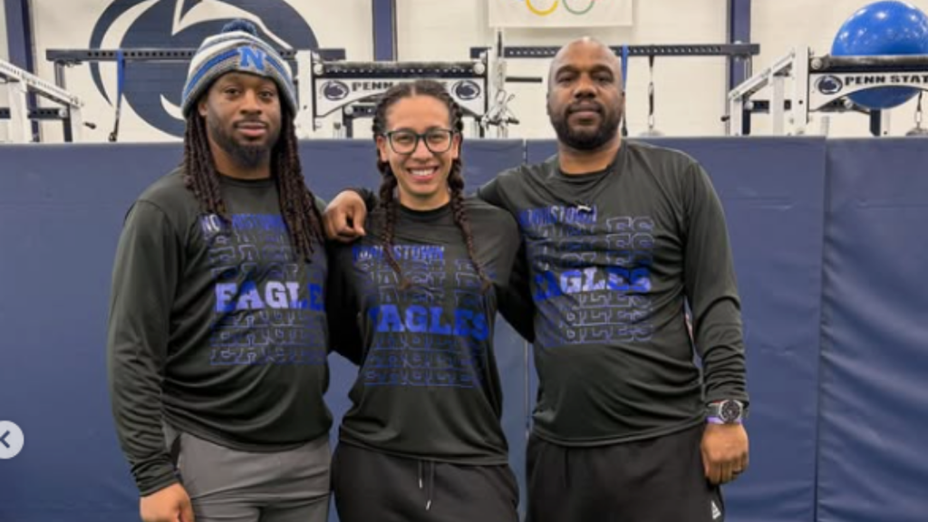 Track coaches pose for photo.