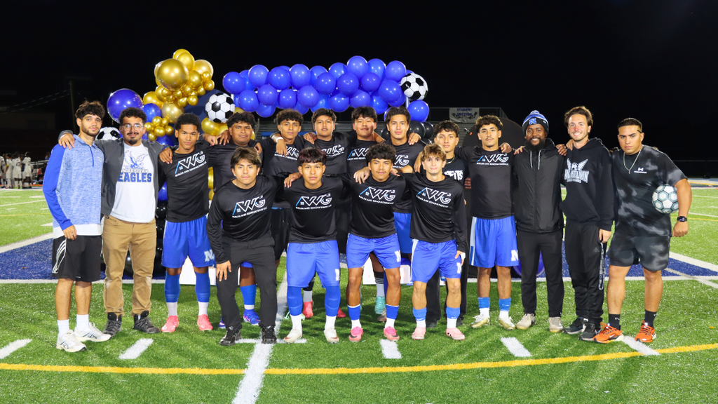 Boys Soccer Senior pose for group photo with coaches.