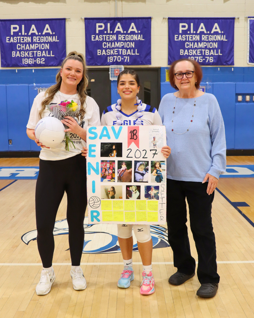 Senior athlete and family holding flowers and poster.