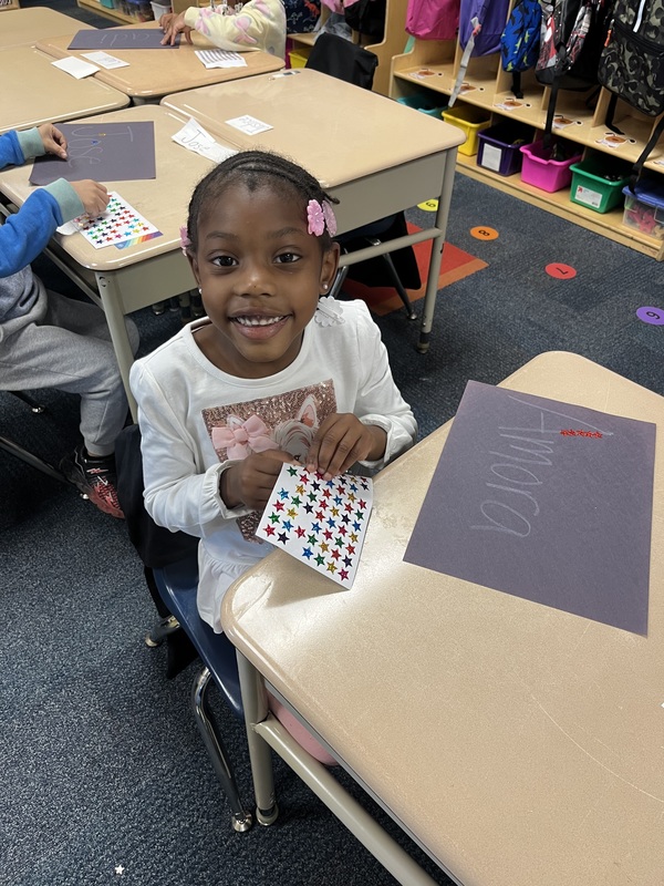Kindergarten student sitting at desk learning in the classroom.