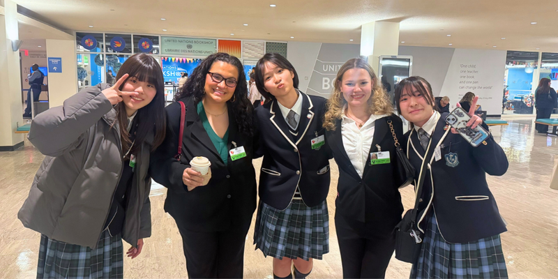 Two NAHS students pose with three international students.
