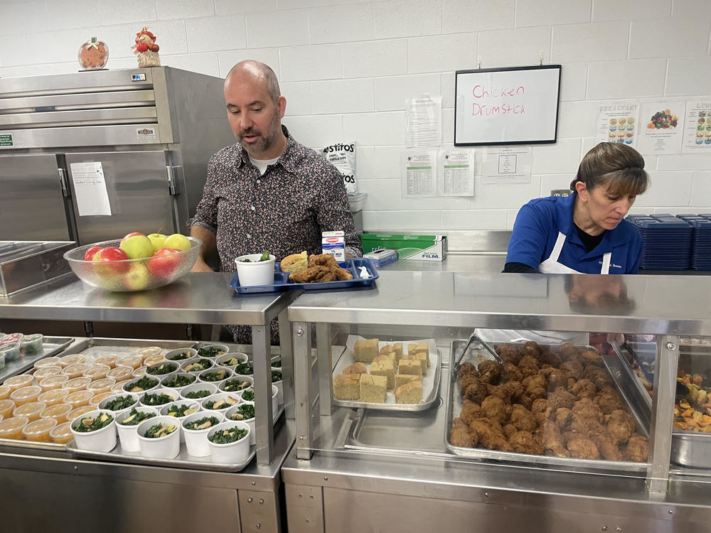 Food Service Director Thomas Lark prepares a lunch tray in the Drury High School kitchen last week. The state was spotlighting the food service department for its use of locally sourced ingredients.