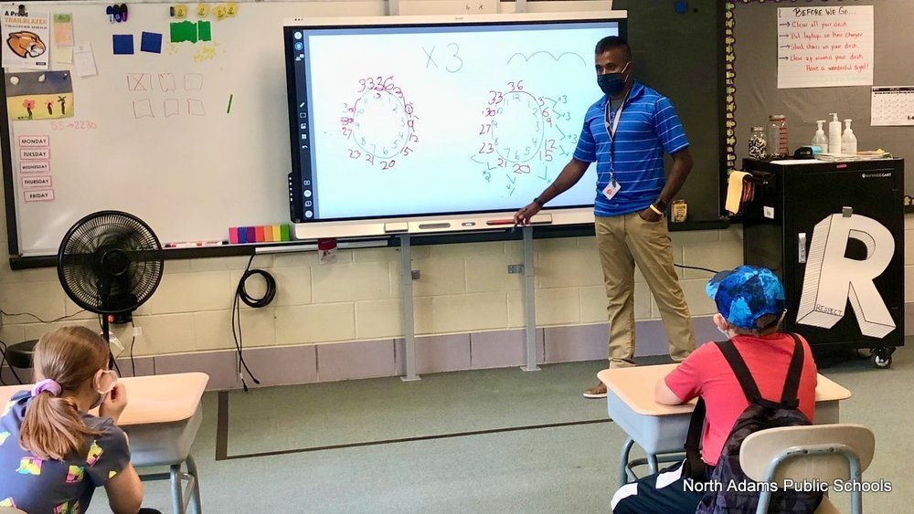 Mr. Labbance using a Smartboard to teach his class.