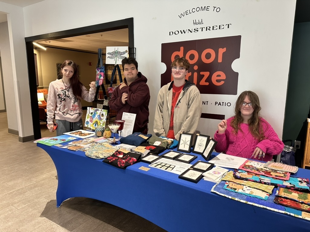 Four students with their art 