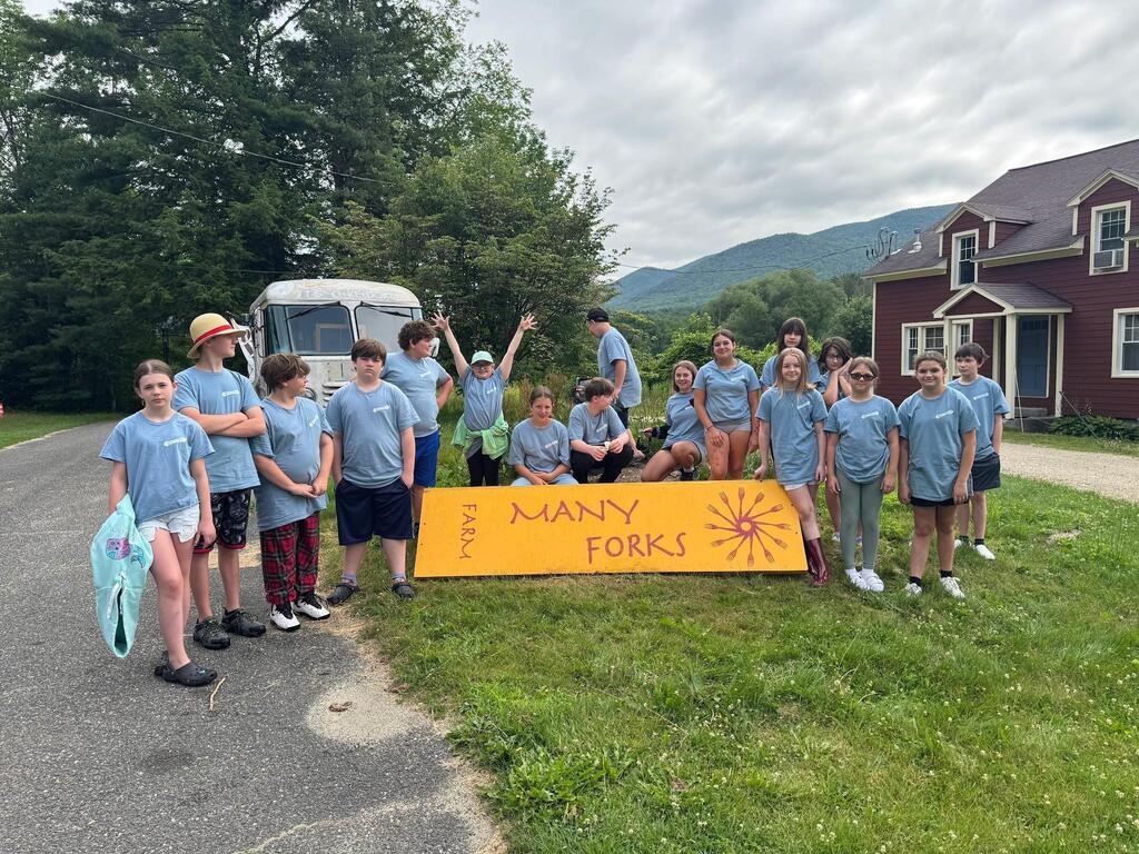 Students holding a banner at Many Forks Farm