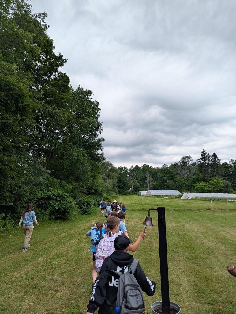 Students ringing the bell on the farm