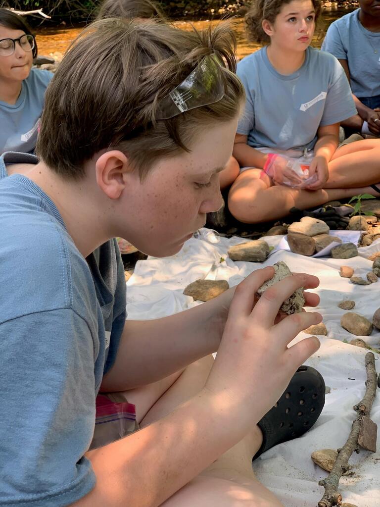 Student examining rocks