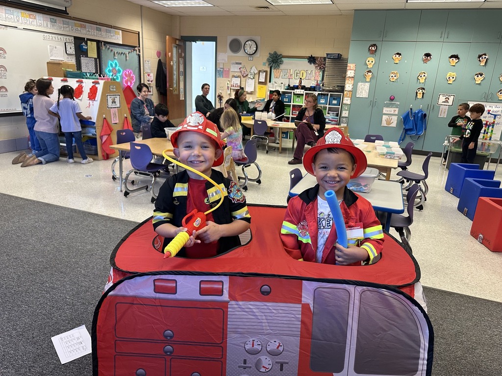 Two PreK students posing as firefighters