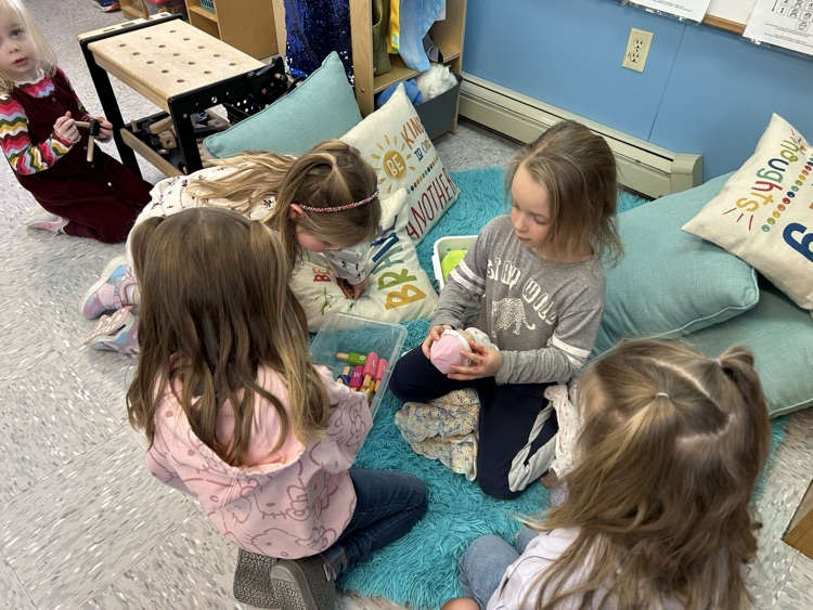 The girls playing with the babies.
