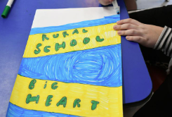 A poster made by a student reads, "Rural School, Big Heart."