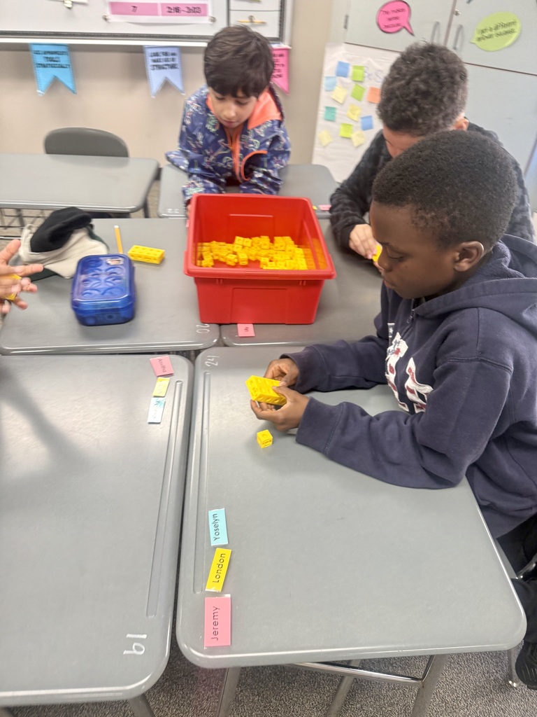 Students building rectangular prisms using unit cubes