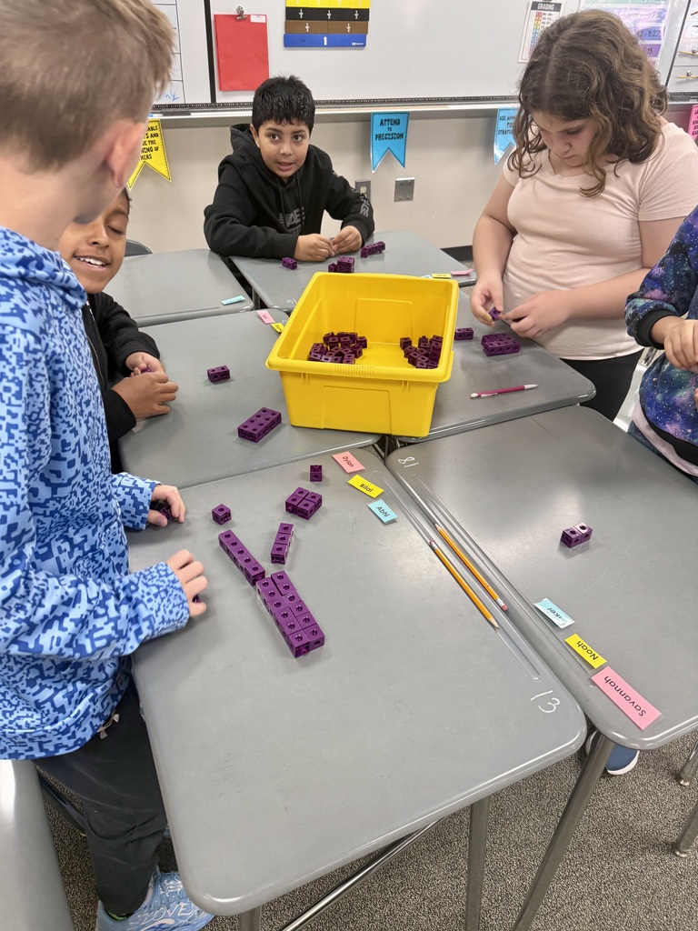 Students building rectangular prisms using unit cubes