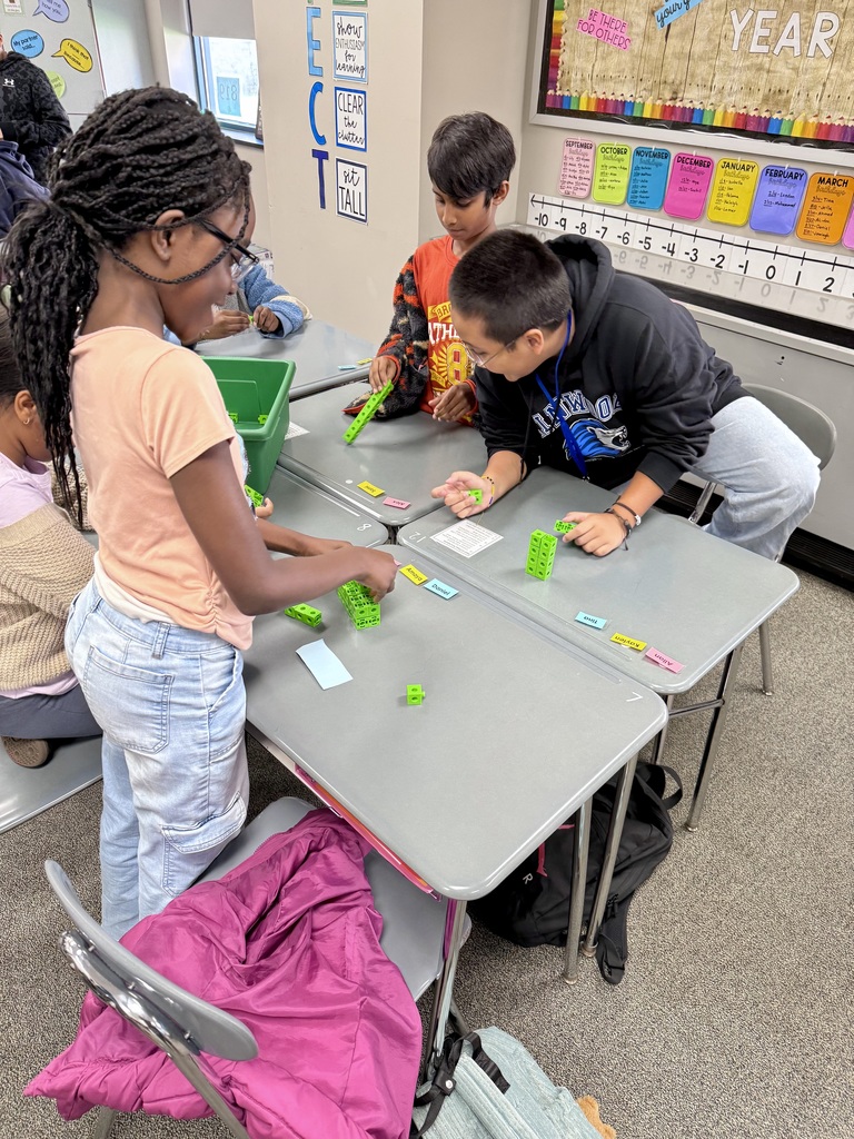 Students building rectangular prisms using unit cubes
