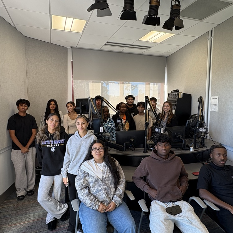 students in an empty audio booth at wmcs radio
