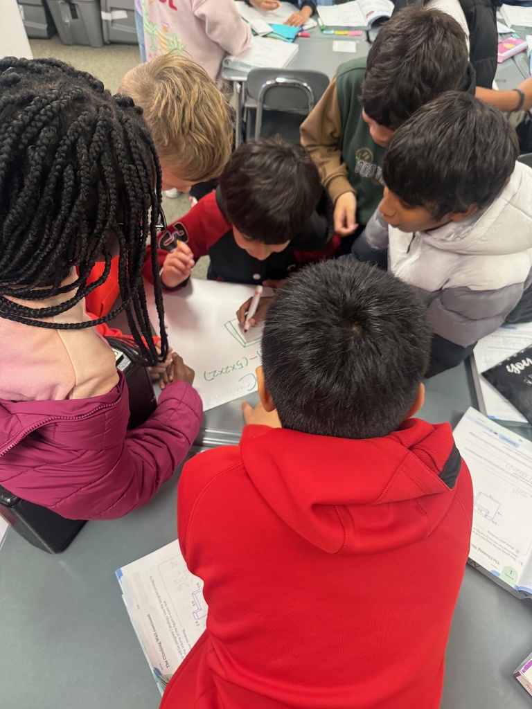 Students collaborating on a poster