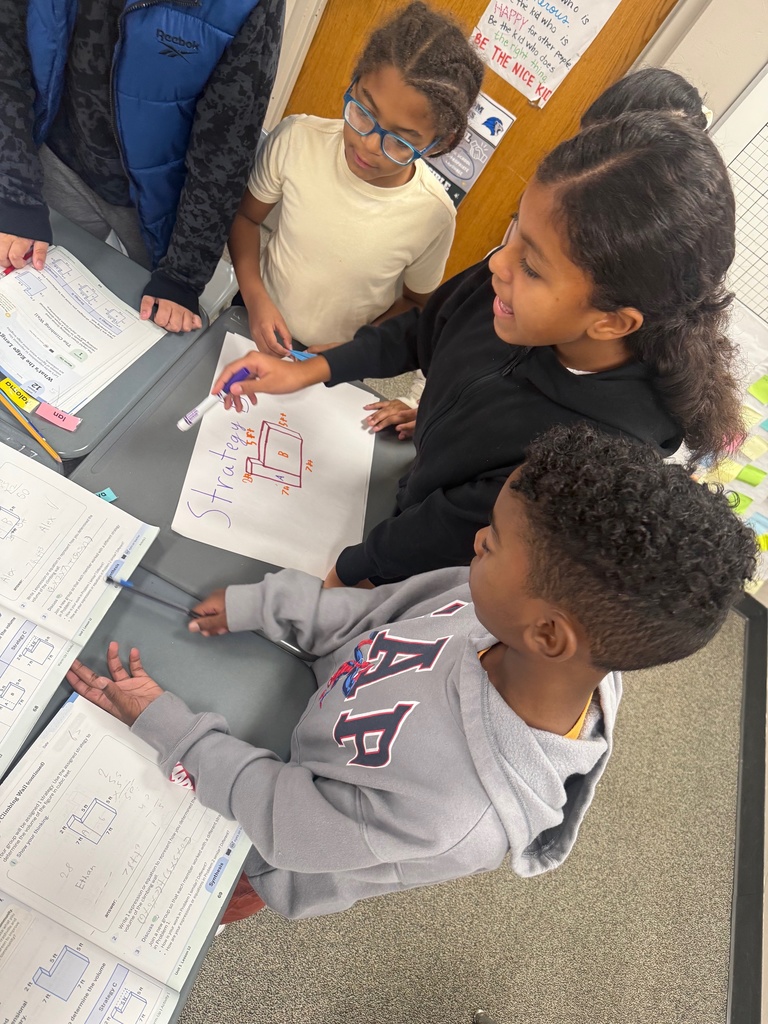 Students collaborating on a poster