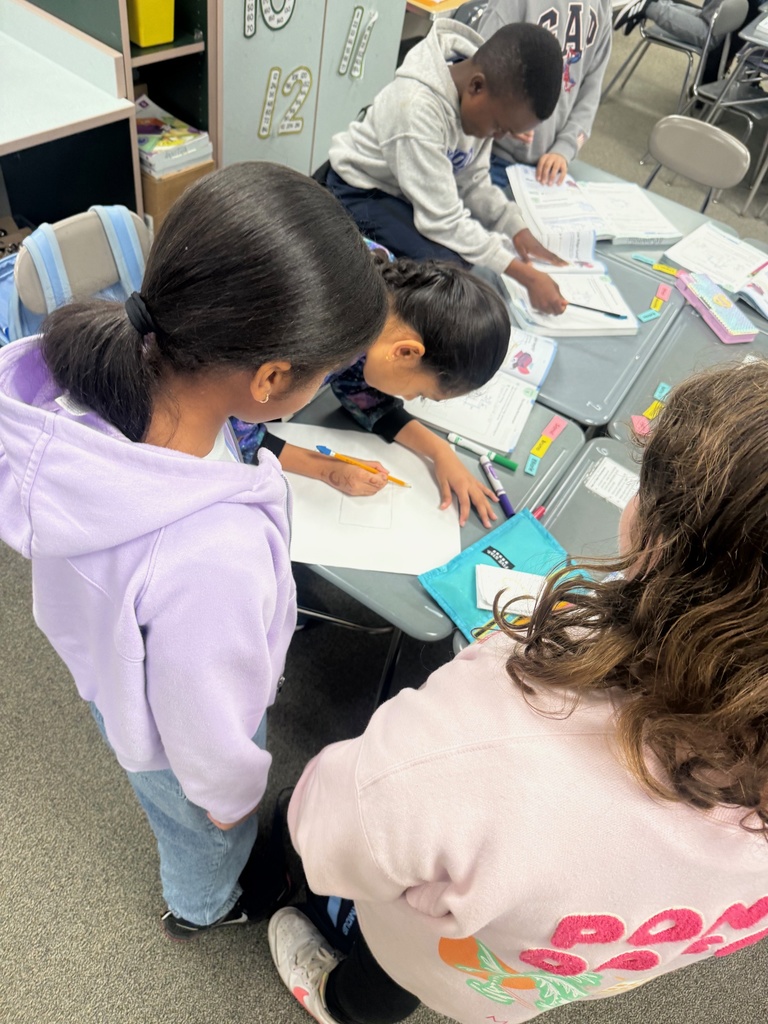 Students collaborating on a poster