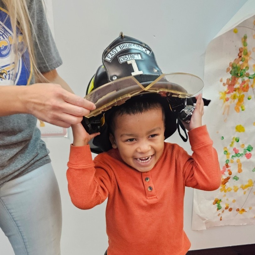Trying on a fire hat!