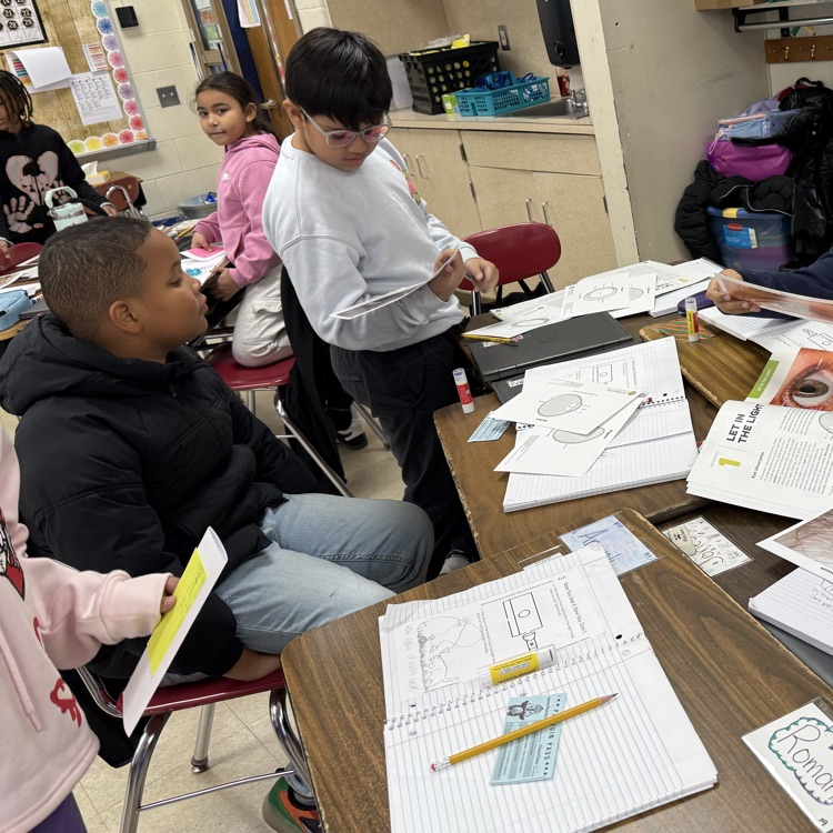 Students looking at cards with eye structures 