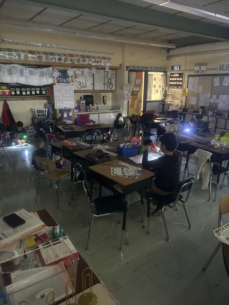 Second graders love independent reading with flashlights!