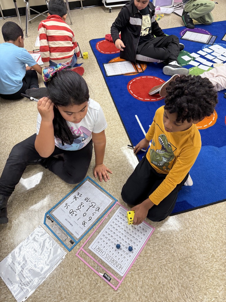 Second graders playing math games with another class!