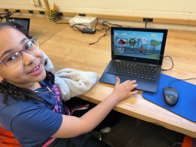 Student smiling with chromebook