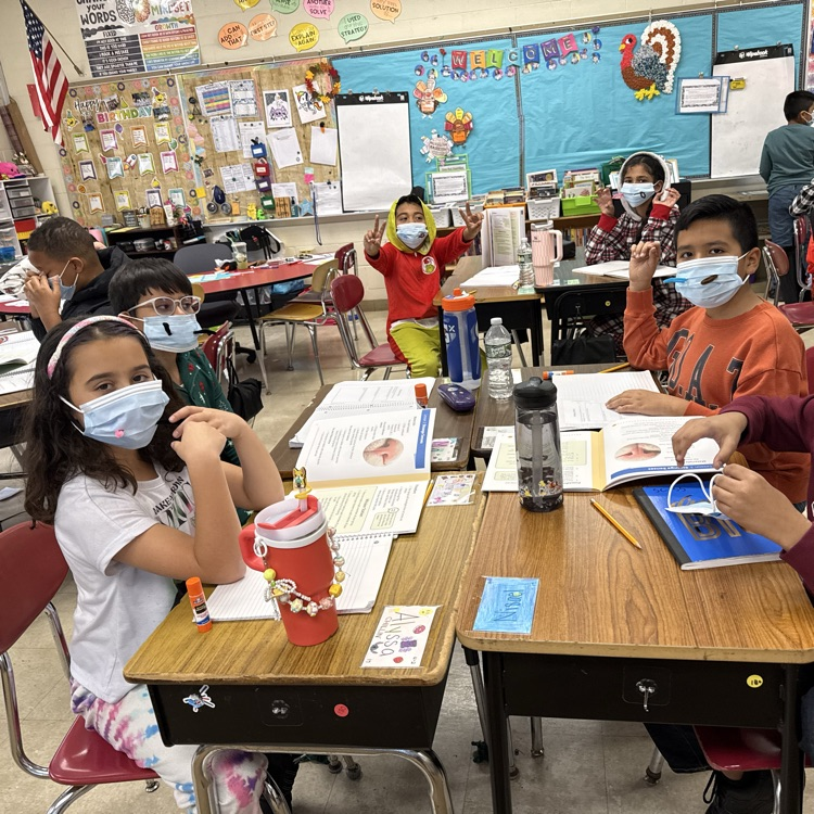 children with masks in a classroom