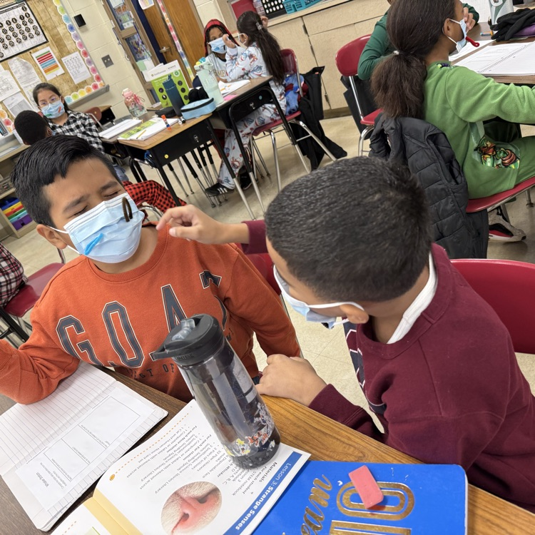 children with masks in a classroom