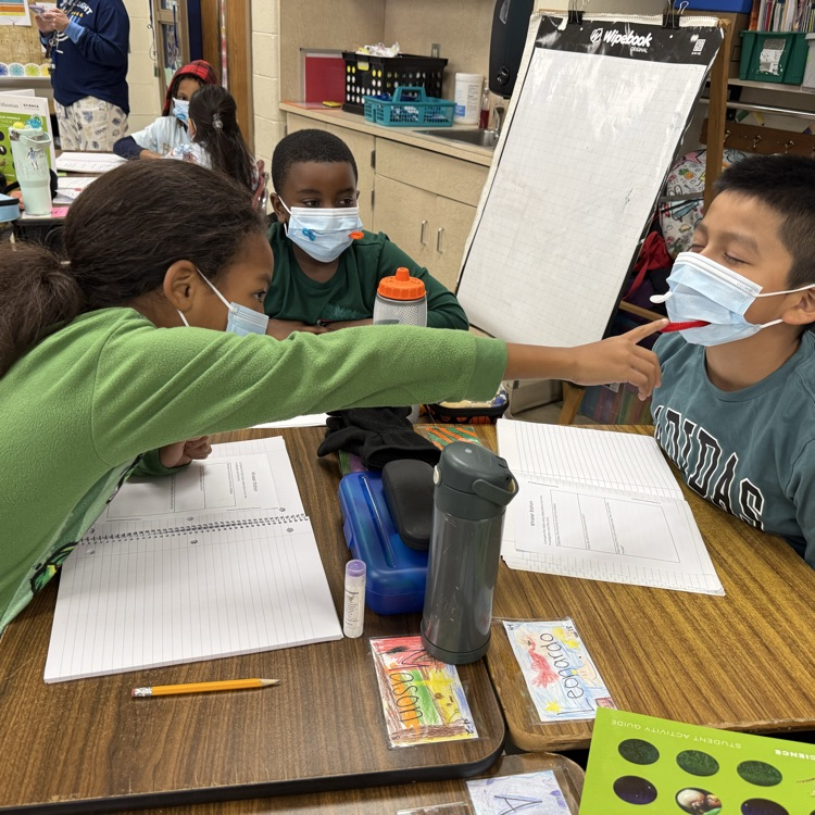 children with masks in a classroom
