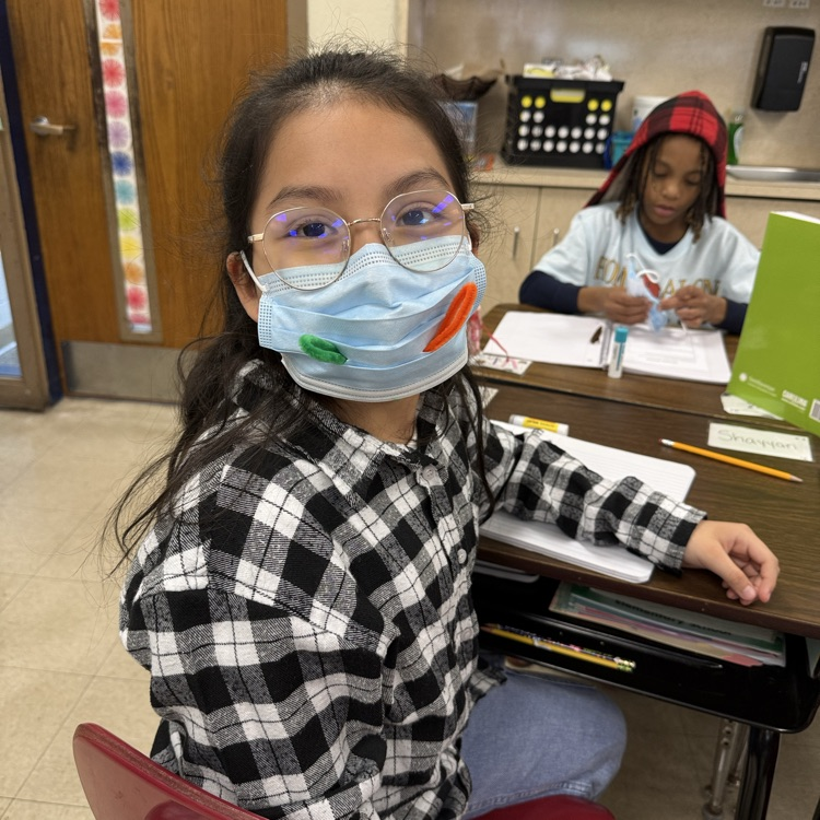 children with masks in a classroom