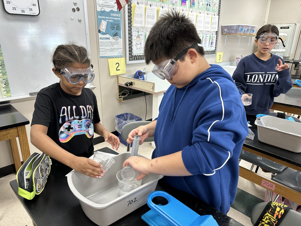 Grade 5 students working on Comparing Mass lab assignment